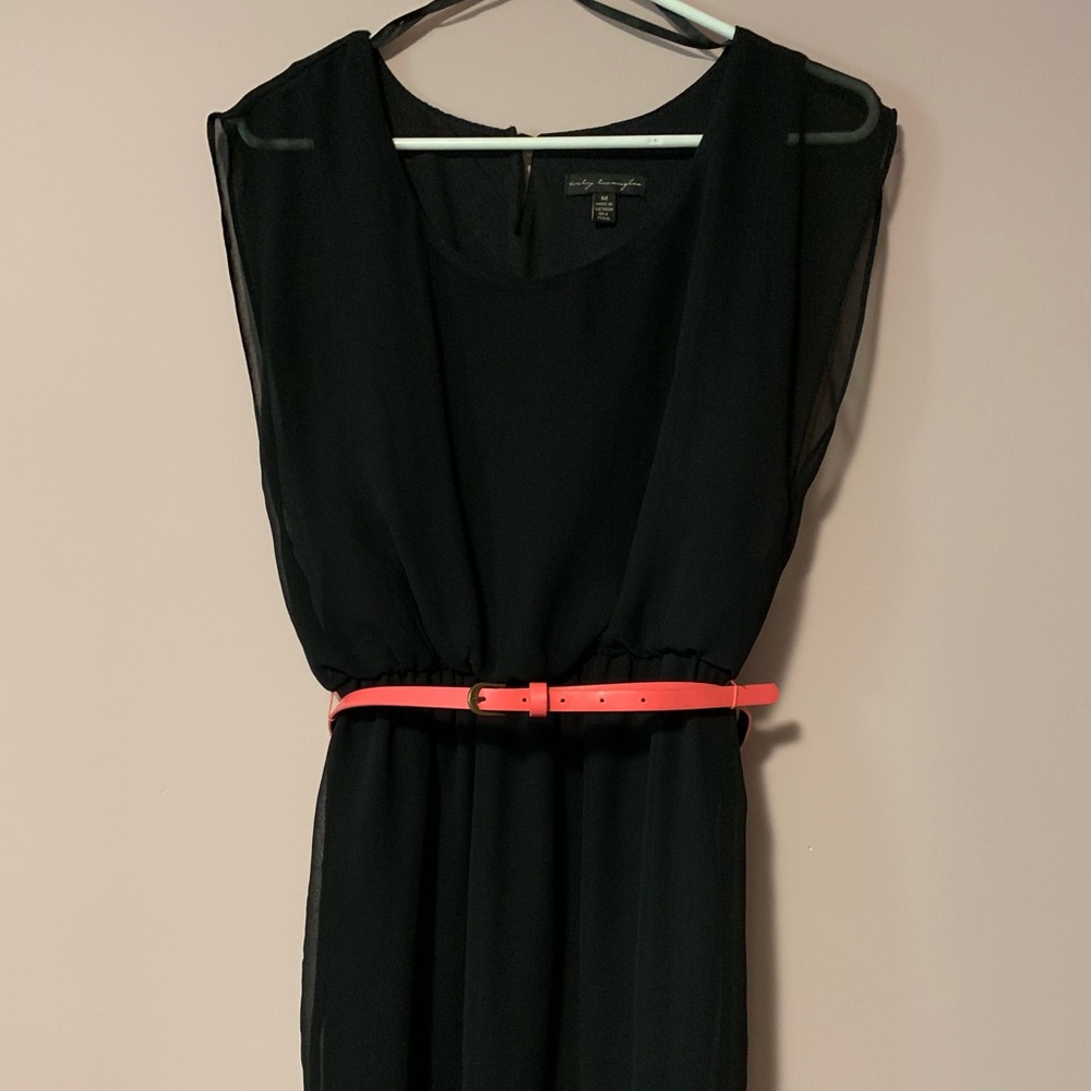 Black mini dress with pink belt.